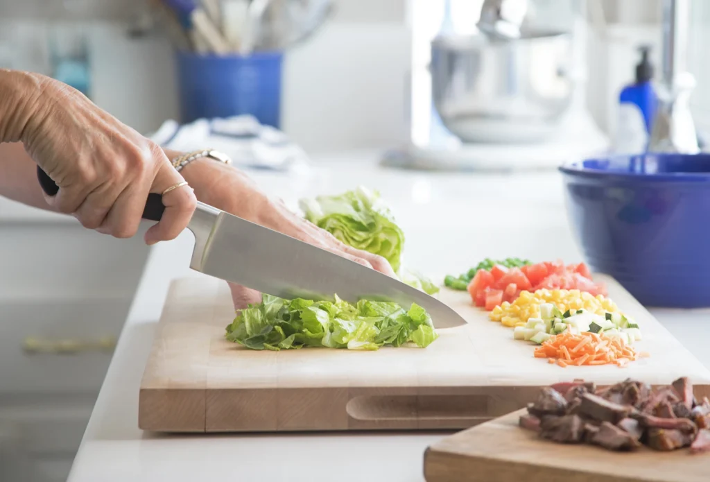 Personal chef chopping fresh vegetables for customized meal prep services in Denver