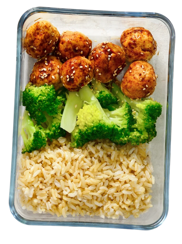 Healthy chicken meatballs, broccoli, and rice prepared by a professional meal prep services provider.