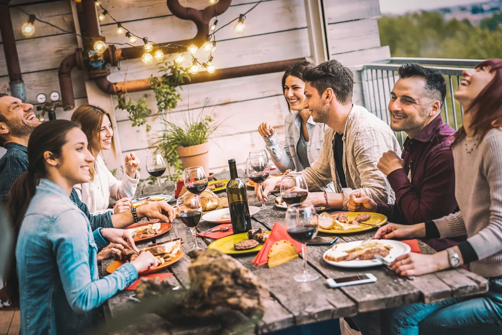 A group gathering at a dinner table for private chef services for dinner parties.